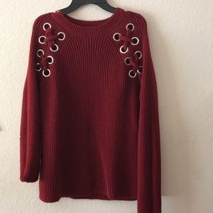 Deep red knit sweater with shoulder design